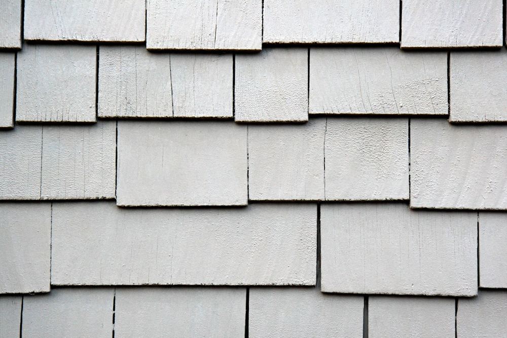 Close-up of weathered gray wood shingles overlapping in rows